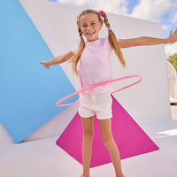 Model can be seen wearing Girls/Tween short sleeve knit top in a light pink and white stripe. Top also features a faux heart pocket to elevate the tee. Paired back perfectly with ivory denim shorts to complete the look. 