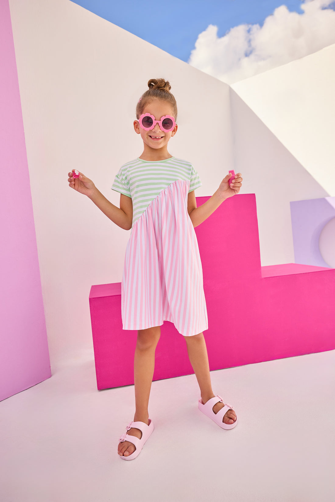 Girls/Tween knit dress in a mixed green and white/pink and white stripe design. Dress is made of a super soft and lightweight knit material and has a fun "swooping" pattern to elevate the look. 