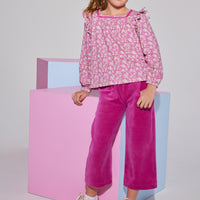 Tween girls square neck, three quarter sleeves with angel sleeve ruffles in a hot pink floral print paired with cropped velour pants in magenta.