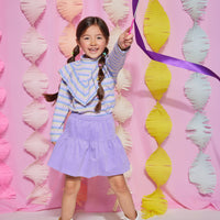 Tween girl turtleneck with blue, purple, and grey stripes that also features a v-ruffle feature down the body of shirt. Pairs back with lilac corduroy skort to complete the look.