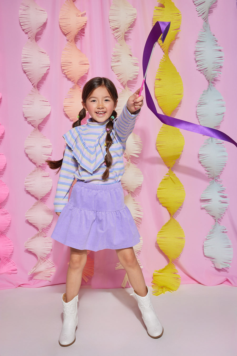 Tween girl turtleneck with blue, purple, and grey stripes that also features a v-ruffle feature down the body of shirt. Pairs back with lilac corduroy skort to complete the look.