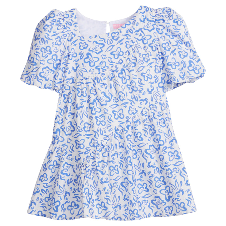 Girls/Tween woven dress in a royal blue and white floral pattern. Dress features a fun asymmetrical hem which adds a fun feature to the dress. Dress also has slight puff sleeves and also has a keyhole button closure on back of neckline. 