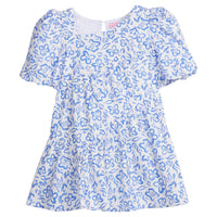 Girls/Tween woven dress in a royal blue and white floral pattern. Dress features a fun asymmetrical hem which adds a fun feature to the dress. Dress also has slight puff sleeves and also has a keyhole button closure on back of neckline. 