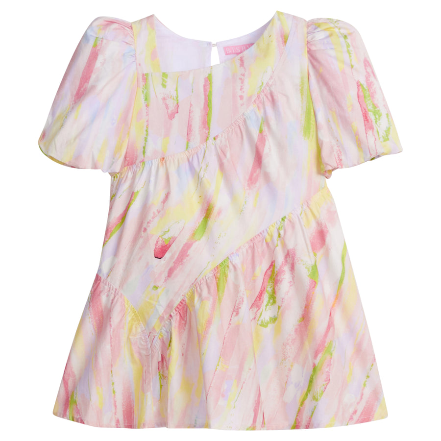 Girls/Tween woven dress in a bright pink/yellow/green watercolor print. Dress features a fun asymmetrical hem which adds a fun feature to the dress. Dress also has slight puff sleeves and also has a keyhole button closure on back of neckline. 