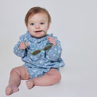 Babygirl longsleeve bubble with elastic wristbands featuring a ruffle neckline with button closures along back and stride in a blue/green/white floral pattern