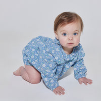 Babygirl longsleeve bubble with elastic wristbands featuring a ruffle neckline with button closures along back and stride in a blue/green/white floral pattern