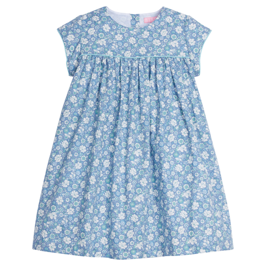 Girls dress featuring our Bedford Gardens Blue Floral. Dress has an aqua trim that goes along the ends of the short sleeves and across the bust of the dress. Dress also has buttons along back making it easy to get in and out of-BISBY