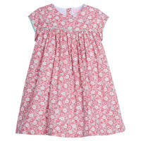 Girls dress featuring our Bedford Gardens Pink Floral. Dress has an aqua trim that goes along the ends of the short sleeves and across the bust of the dress. Dress also has buttons along back making it easy to get in and out of-BISBY