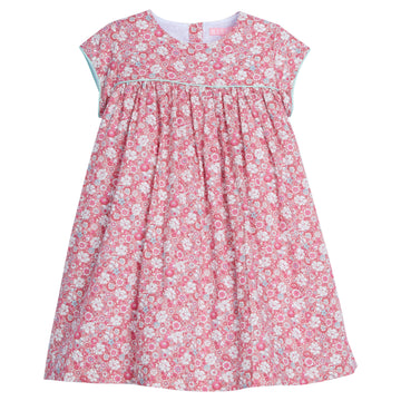 Girls dress featuring our Bedford Gardens Pink Floral. Dress has an aqua trim that goes along the ends of the short sleeves and across the bust of the dress. Dress also has buttons along back making it easy to get in and out of-BISBY