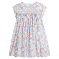 Girls/Tween woven short sleeve dress in a pale yellow with pink/red/blue/green floral print. Dress features button closure at back and a light pink trim detail at bust which adds some fun volume that also continues onto the trim of the sleeves as well.