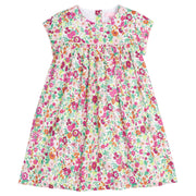 Girls dress featuring our Magenta Floral. Dress has a light pink trim that goes along the ends of the short sleeves and across the bust of the dress. Dress also has buttons along back making it easy to get in and out of-BISBY