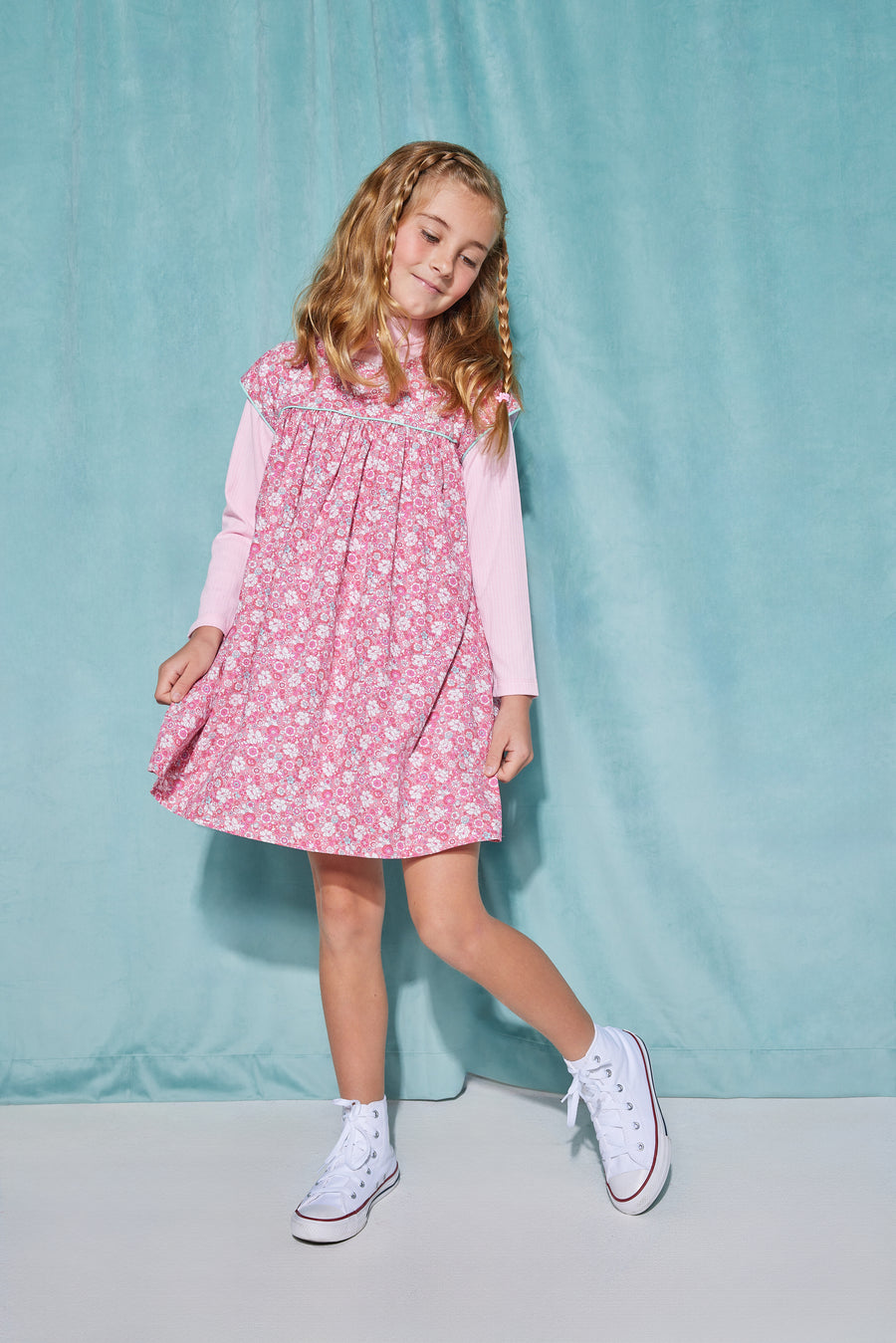 Girls short sleeve dress in pink/aqua/white floral pattern with aqua trim detailing that has button closures along back paired with a turtleneck in light pink underneath.