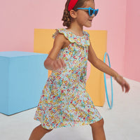 Young girl wearing flora dress with colorful flower print from BISBY.