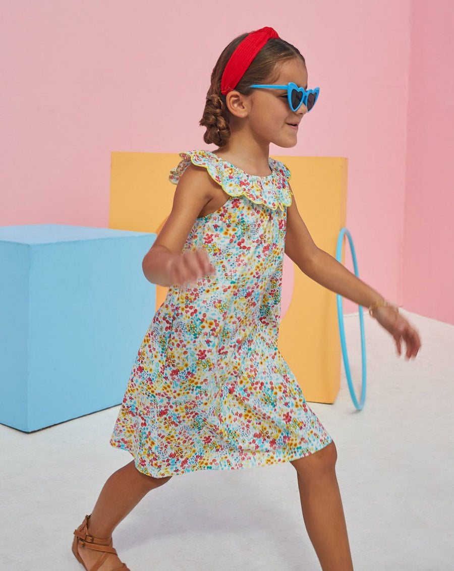 Young girl wearing flora dress with colorful flower print from BISBY.