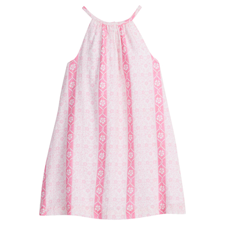 Girls/Tween woven dress in a light pink/hot pink floral print. Dress features a halter neckline and has button closures along back for a relaxed but secure fit. 