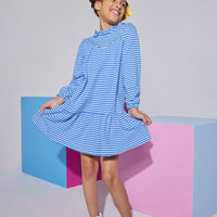 Girl/tween knit long sleeve light blue/dark blue stripe dress that features a ruffle neckline with a button closure at back of neck and elastic cuffs at end of sleeves.