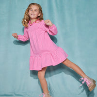 Girl/tween long sleeve knit dress in hot pink/light pink stripe pattern that features a ruffle neckline with a single button closure on back of neck and elastic cuffs at end of sleeves.