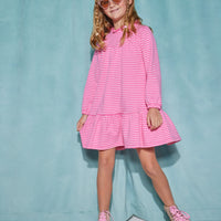 Girl/tween long sleeve knit dress in hot pink/light pink stripe pattern that features a ruffle neckline with a single button closure on back of neck and elastic cuffs at end of sleeves.