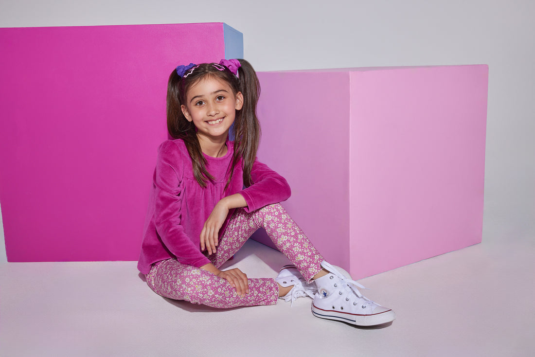 Girls/tween knit leggings in a fuchsia/white floral print , made of a super lightweight stretchy material that also feature a small ricrac/scallop detail at the ankles. Leggings can be seen paired with a long sleeve magenta velour top to complete the look.