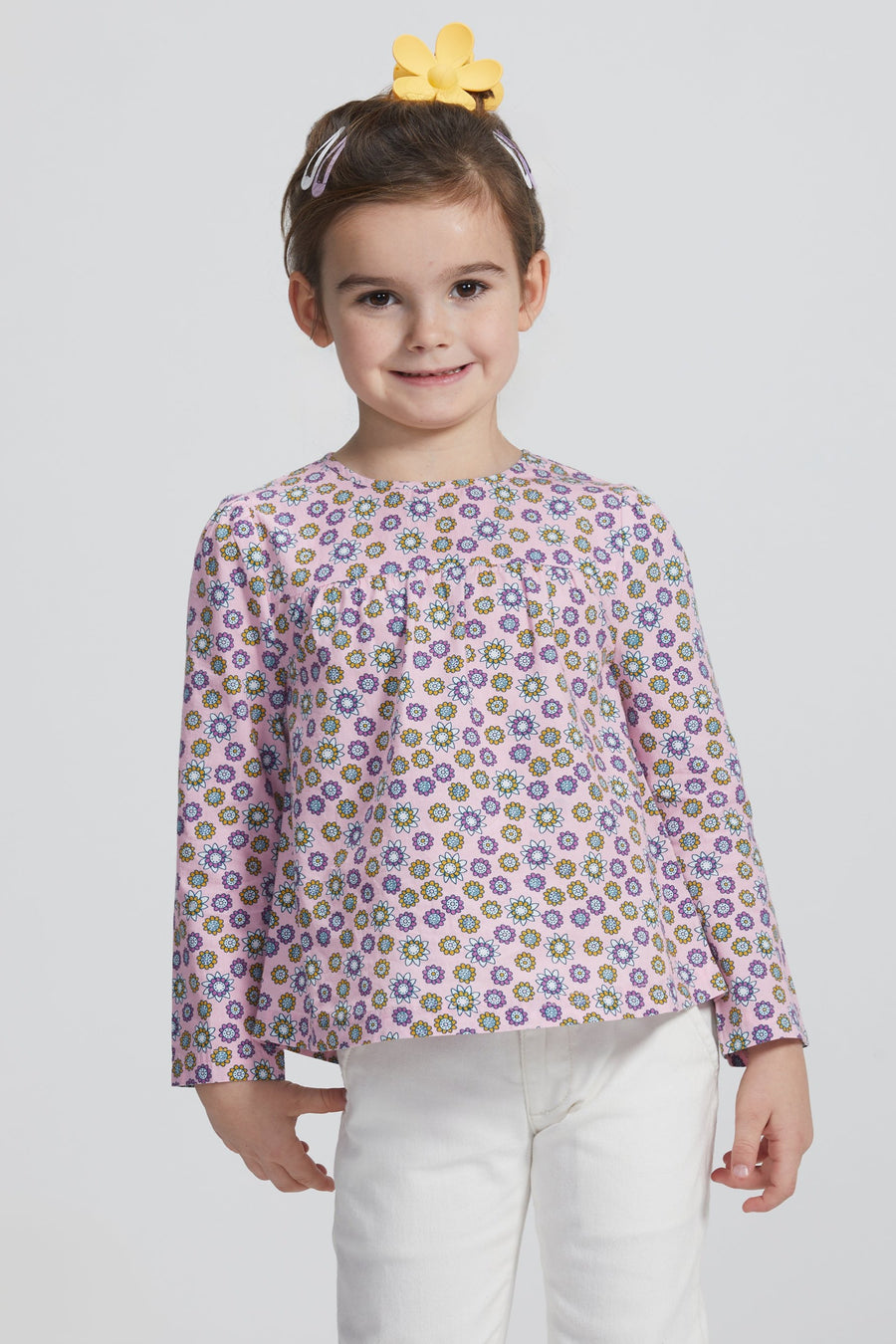 Girl/Tween woven long sleeve top in a pink/purple/yellow floral pattern. Top features button closures along back for a relaxed but secure fit.