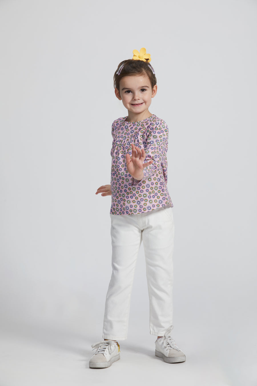 Girl/Tween woven long sleeve top in a pink/purple/yellow floral pattern. Top features button closures along back for a relaxed but secure fit.Model can also be seen wearing our ivory denim jeans to complete the look. 