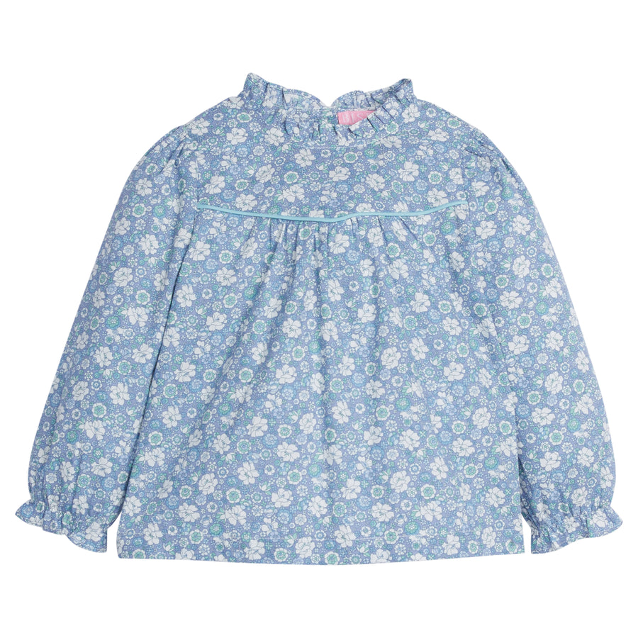 Girls/Tween top in our Bedford Gardens Blue floral which features a blue/aqua/white floral arrangement. Top has an aqua trim detail along the bust, elastic cuffs on the sleeves, ruffles at the neckline, and there are buttons along back as well -BISBY