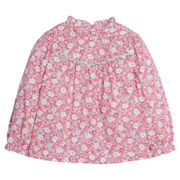 Girls/Tween top in our Bedford Gardens Pink floral which features a pink/turquoise/white floral arrangement. Top has a turquoise trim detail along the bust, elastic cuffs on the sleeves, ruffles at the neckline, and there are buttons along back as well -BISBY