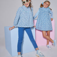 Girls/Tween woven long sleeve top in a blue/green floral print which features a ruffled neckline, elastic cuffs at end of sleeves, and an gathering detail at bust for a relaxed fit. Top pairs back perfectly with dusty blue corduroy pants and print also comes in a dress as well which can pair back with a ribbed turtleneck in light blue.