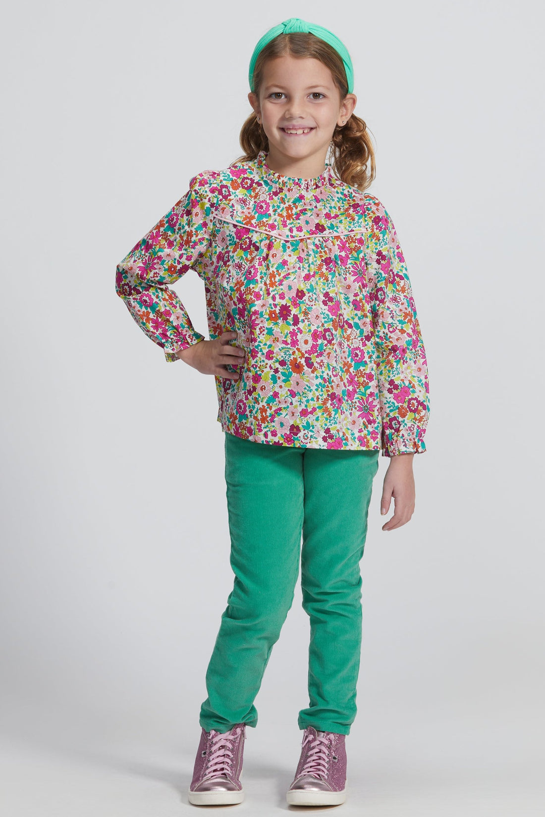 Girls/Tween lightweight corduroy pants in a pine green that feature a button snap closure for easy put on access and also has pockets in the front and back. Model can be seen wearing a woven long sleeve top in a beautiful floral to complete the look. 