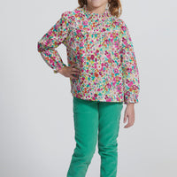 Girls/Tween lightweight corduroy pants in a pine green that feature a button snap closure for easy put on access and also has pockets in the front and back. Model can be seen wearing a woven long sleeve top in a beautiful floral to complete the look. 