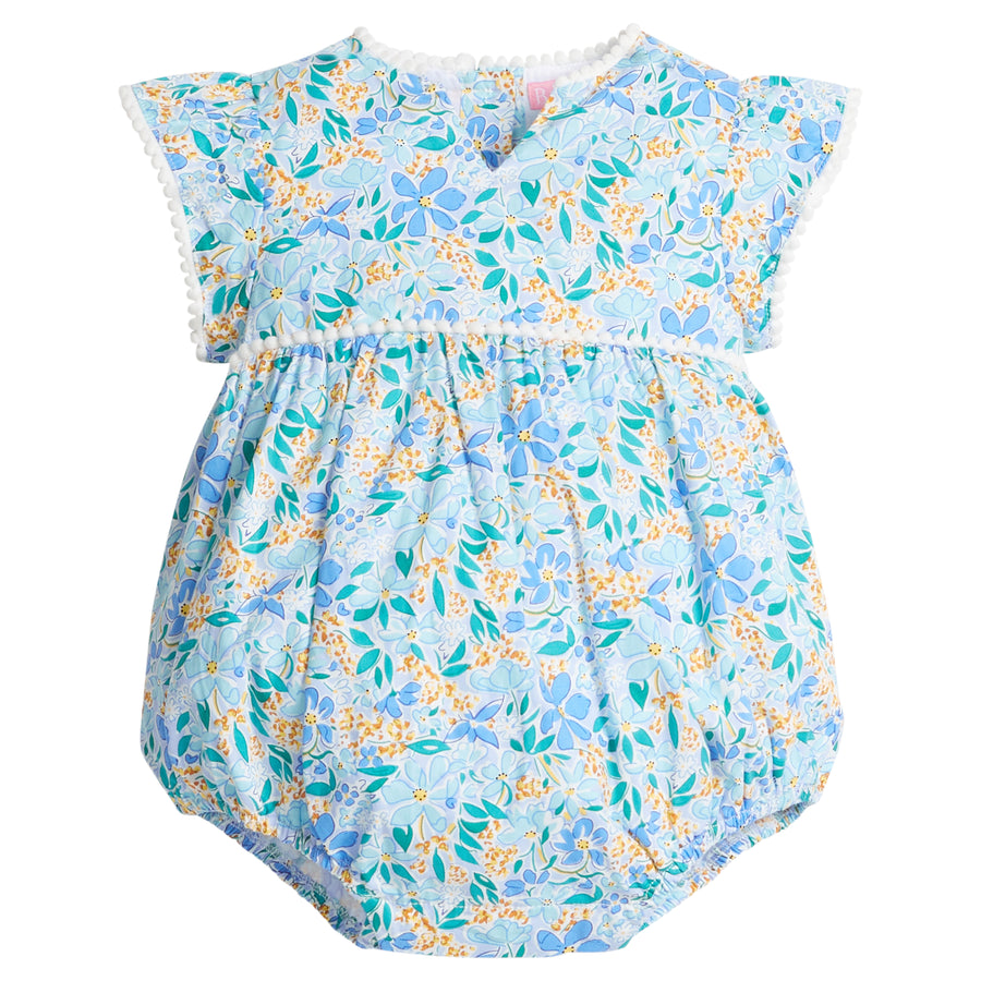 Baby girl woven bubble with ruffle/angel sleeves and slight v-neck neckline and multi-color blue and yellow flowers printed across the body. The bust-line and sleeves are also lined with white pom poms and there are button closures along the stride. 