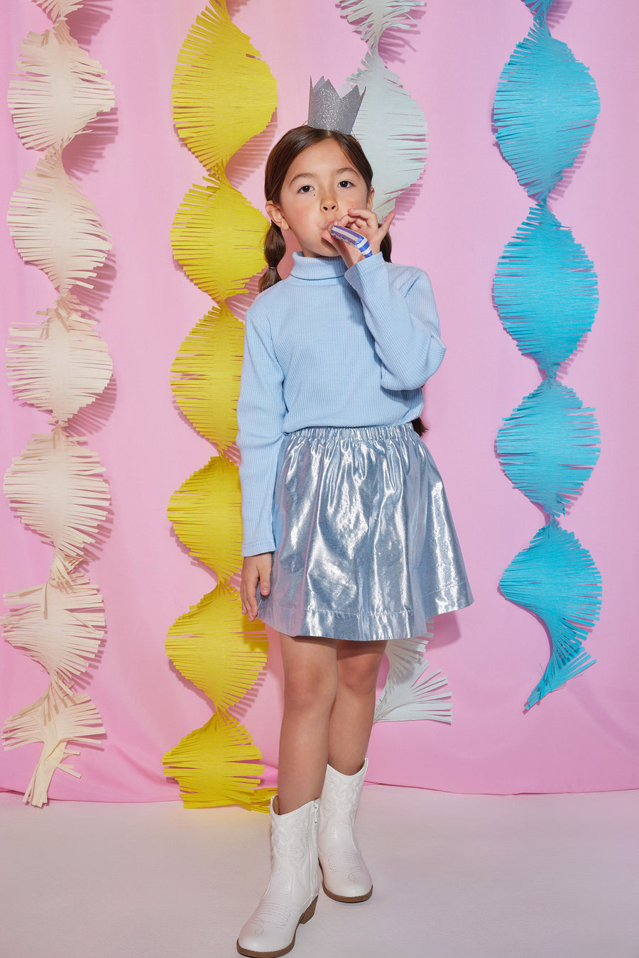 Tween skort with built in shorts and an elastic waistband in a icicle blue metallic color paired back with an ice blue ribbed turtleneck to complete the look.