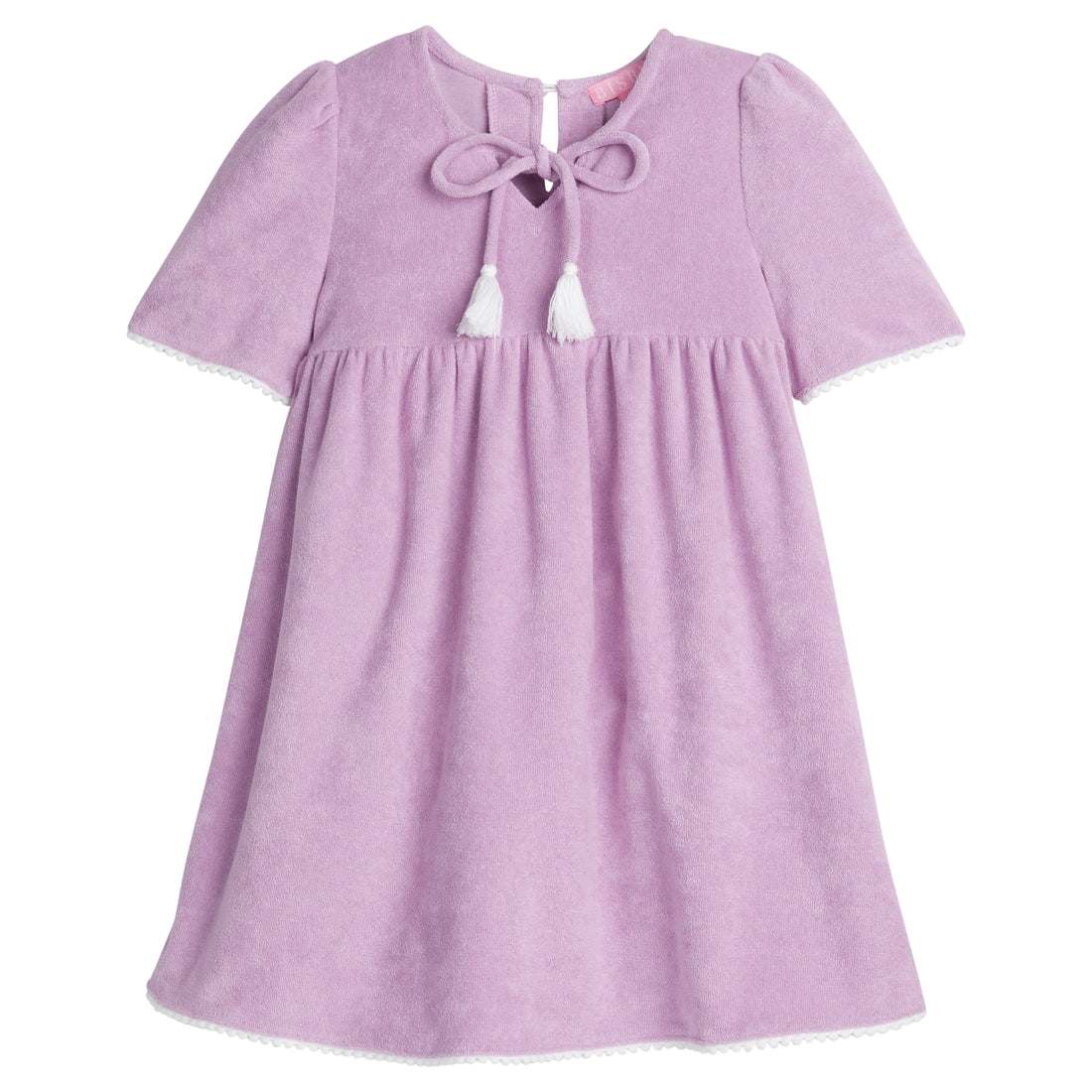 Girls/Tween lilac terry cloth dress that features a slight v-neckline, light pink pom pom detail at sleeves, and tie tassels at top of neckline. There is also a button closure at back for a relaxed but secure fit. 