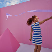 Girl/tween woven romper with pockets and elastic tie waistband with thick royal blue and white stripes.