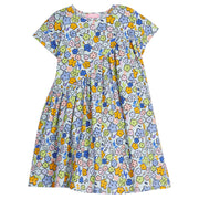 Girls/Tween knit dress in our Cartoon floral pattern which features an arrangement of cartoon flower drawings in orange/blue/pink/green printed on a light blue background. Dress also has a "swoop" detail through the front to add a ruching effect-BISBY