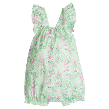 Baby girl bubble with adjustable ruffle straps and elastic along leg openings. Has a light pink and white floral print on top of a light green background.