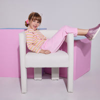 Girl/Tween cropped velour pants in the light pink velour shade. Pants feature a soft velour material, with pockets in the front, and an elastic waistband for a comfy fit. Model can be seen wearing a knit top with angel sleeves in a pastel stripe pattern to complete the look. 